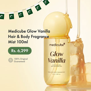 Medicube Glow Vanilla Hair & Body Fragrance Mist 100ml bottle with a golden liquid design, set against a warm cream background with decorative Pakistani flag banners and a honey-like drip graphic.