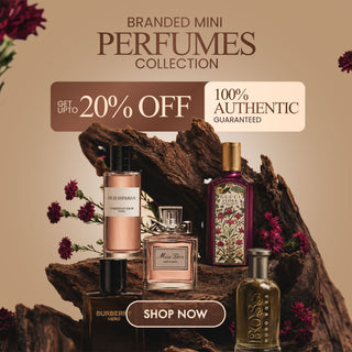 Promotional graphic for a Branded Mini Perfumes Collection, featuring several perfume bottles arranged on a piece of driftwood with flowers. Visible brands include Aodh O'Nullivan, Miss Dior, Burberry, Hugo Boss, and Tom Ford.