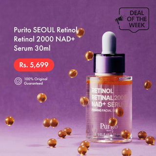 Purito Seoul Retinol 2000 NAD+ Serum 30ml bottle on a purple background with floating gold serum droplets. The image includes promotional text in English and a 'Deal of the Week' badge.
